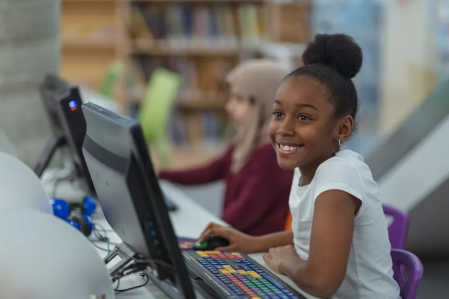 girl smiling at computer